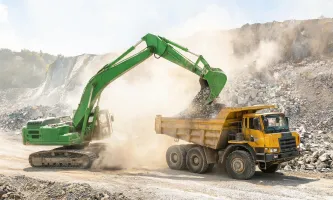 Earthmoving excavator on quarry haul road