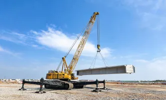 Crawler crane lifting precast beam